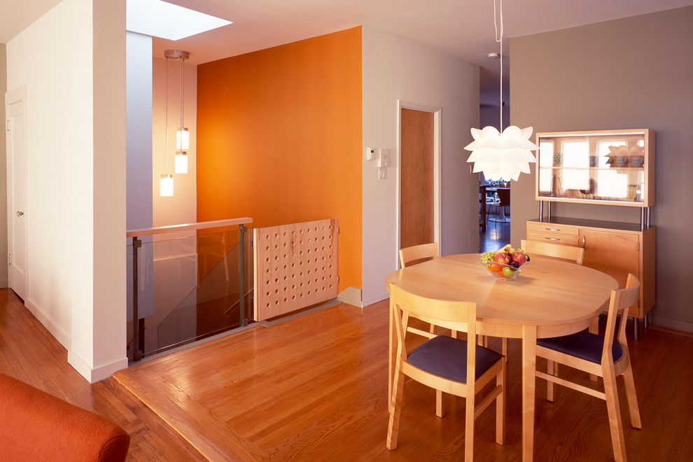 Mid-sized minimalist medium tone wood floor great room photo in San Francisco with multicolored walls