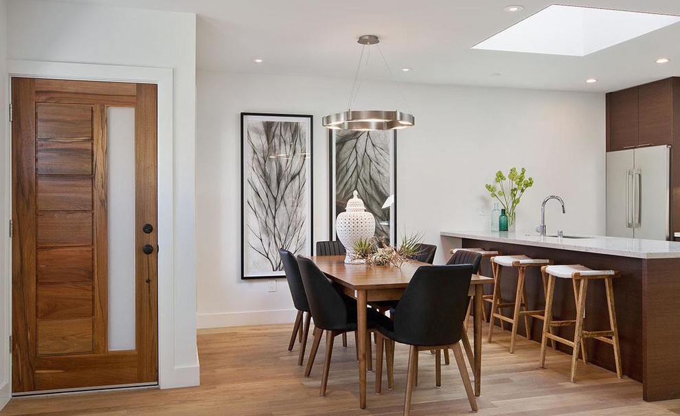 Design ideas for a contemporary open plan dining room in Los Angeles with white walls and light hardwood flooring.