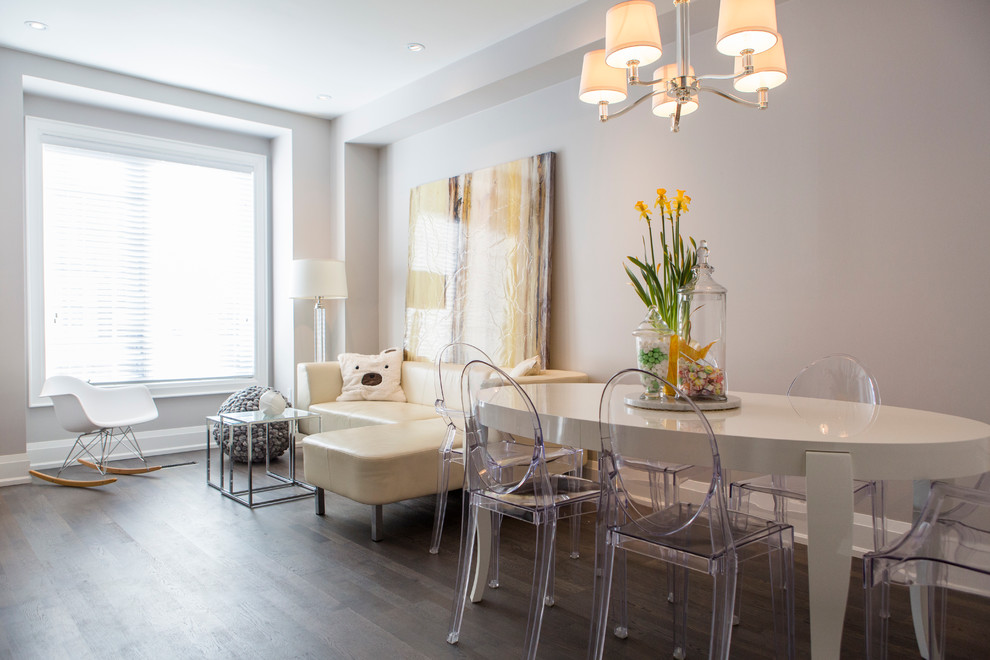 Inspiration for a contemporary open plan dining room in Toronto with beige walls and medium hardwood flooring.