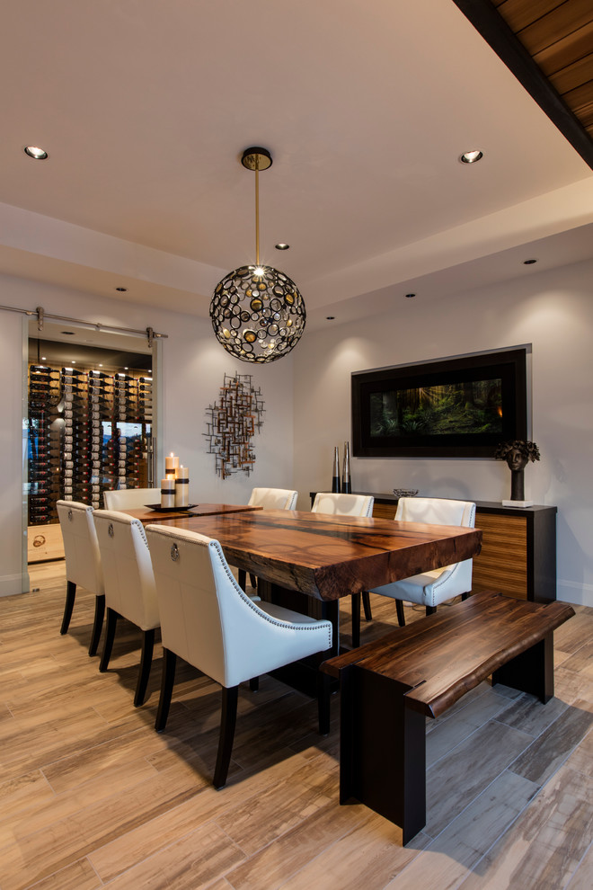 Cette image montre une salle à manger ouverte sur le salon design de taille moyenne avec un mur gris, parquet clair, un sol marron et aucune cheminée.