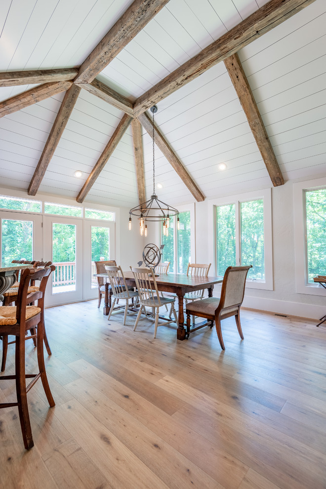 Diseño de comedor de estilo de casa de campo de tamaño medio abierto con paredes grises y suelo de madera clara