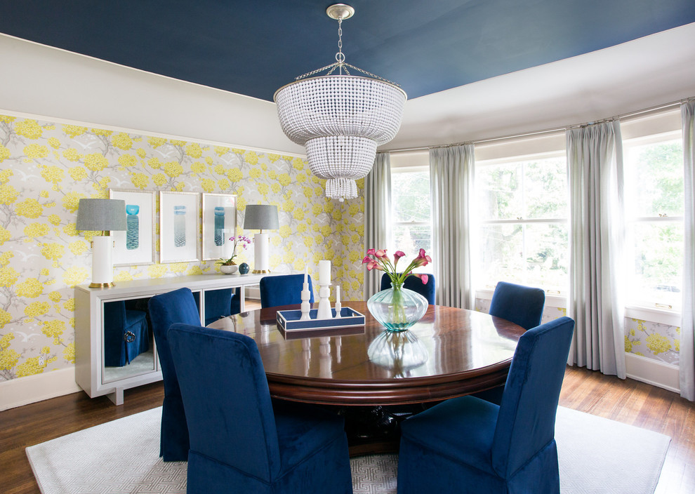 Eclectic dining room in Chicago with yellow walls, dark hardwood flooring and brown floors.
