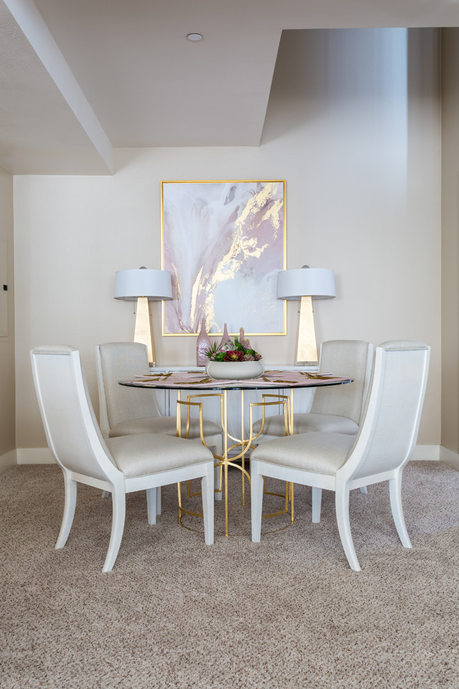 Design ideas for a small contemporary dining room in Orange County with beige walls, carpet, no fireplace, beige floors and feature lighting.