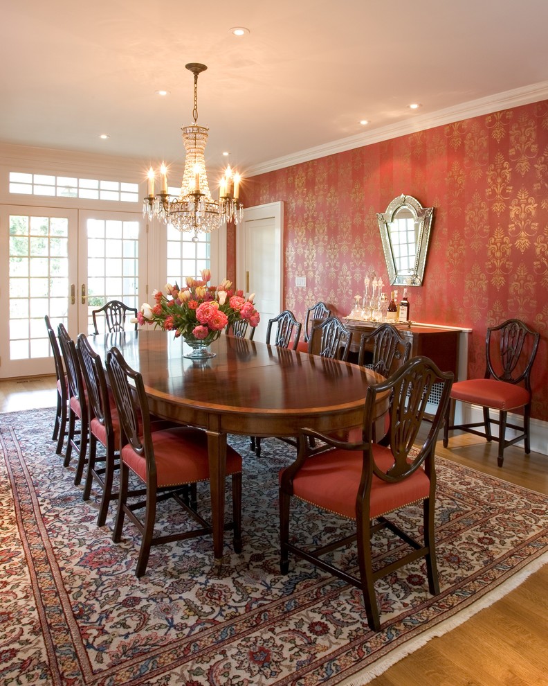 Inspiration for a traditional dining room in New York with red walls and medium hardwood flooring.