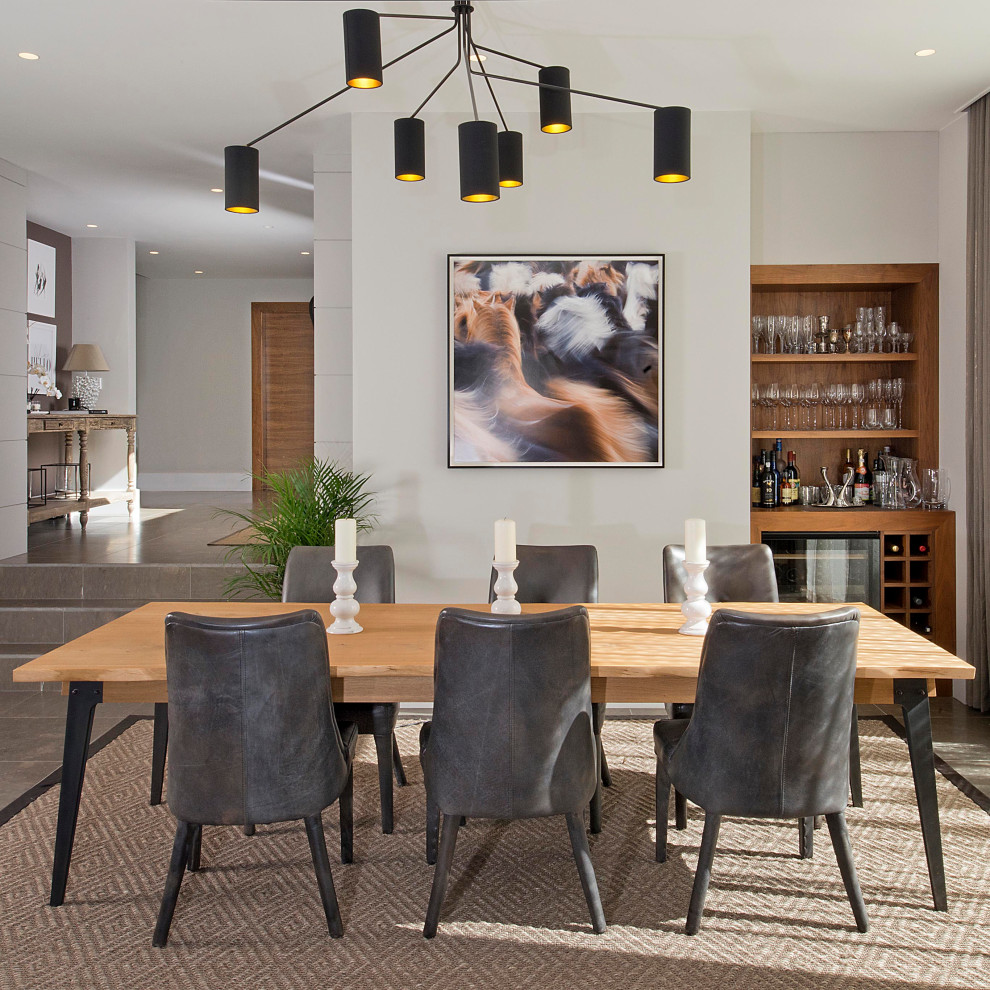 Design ideas for a contemporary dining room in Cheshire with white walls and grey floors.