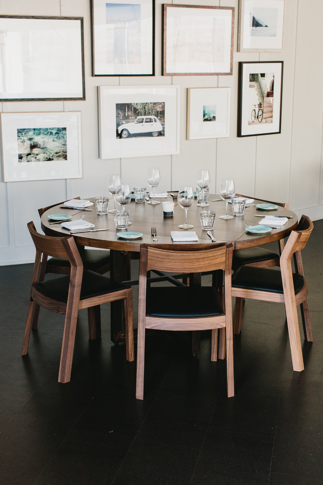 Mid-sized minimalist dark wood floor enclosed dining room photo in Atlanta with white walls