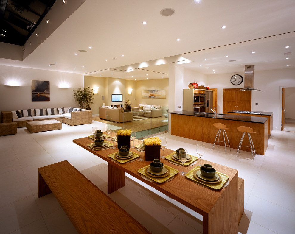 This is an example of a contemporary open plan dining room in London with white walls.