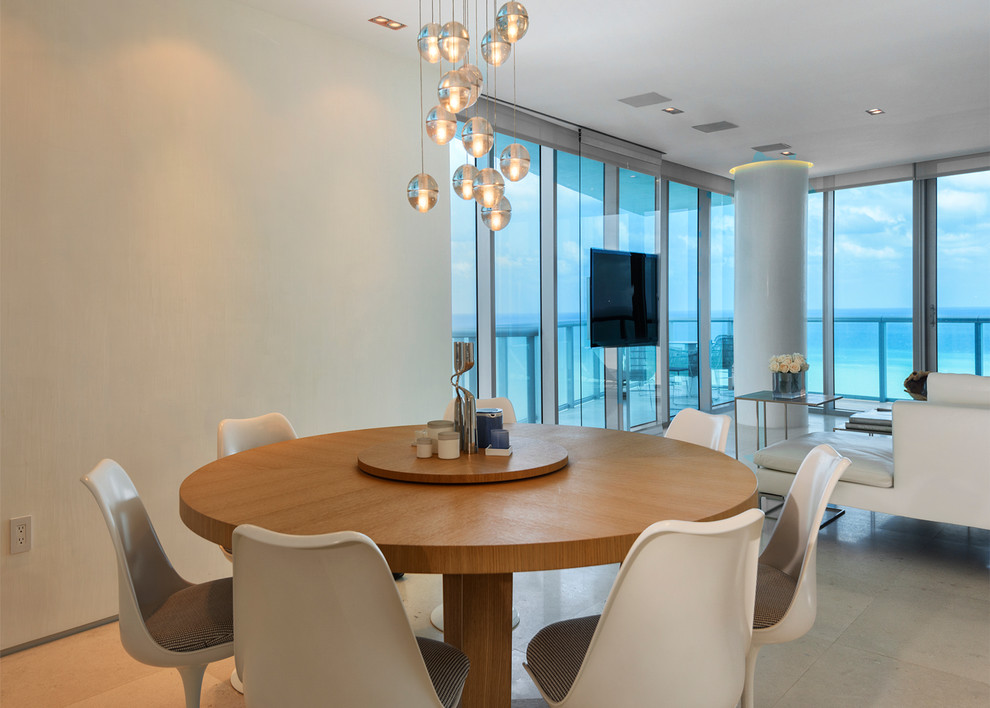 Dining room - mid-sized contemporary limestone floor dining room idea in Miami