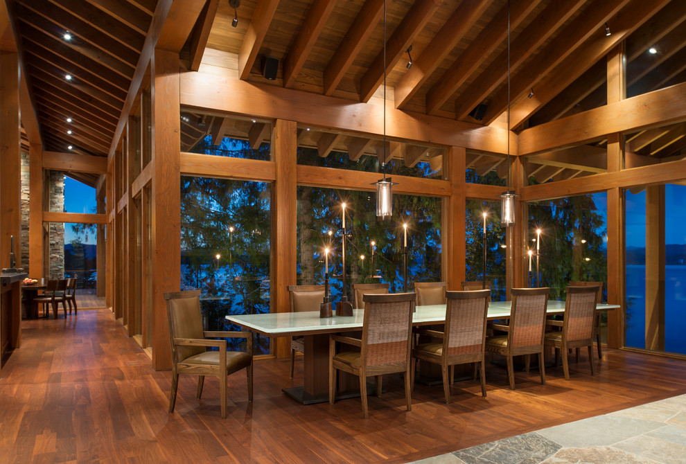 Design ideas for a rustic open plan dining room in Seattle with dark hardwood flooring.