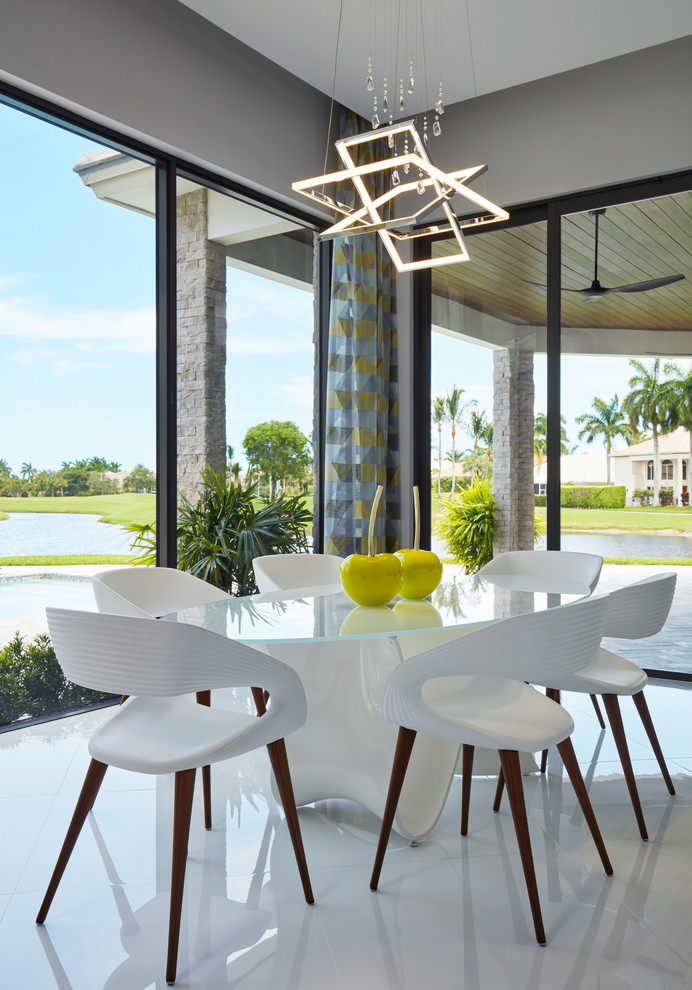 This is an example of a contemporary dining room in Miami with grey walls and white floors.