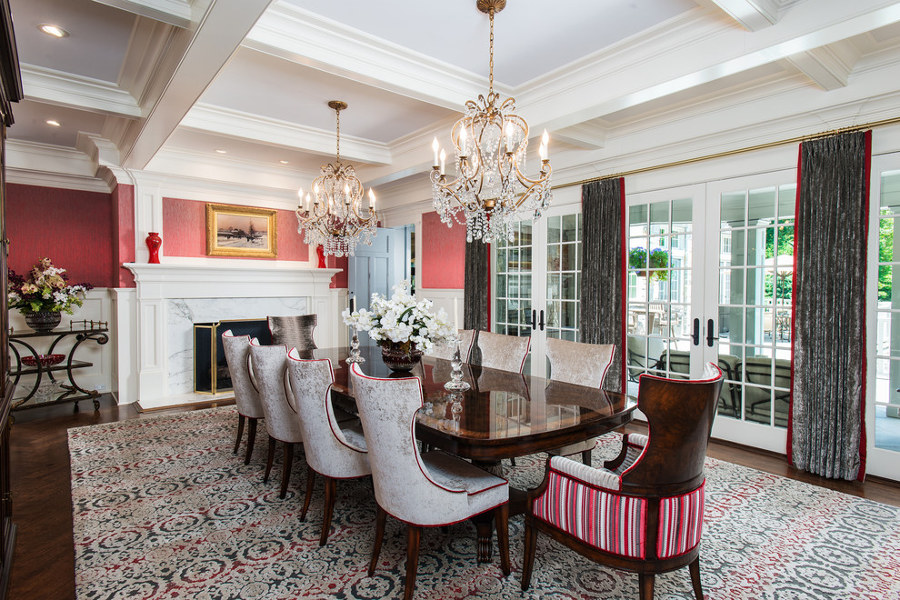 Traditional dining room in New York with a standard fireplace, a stone fireplace surround, brown floors, red walls and dark hardwood flooring.