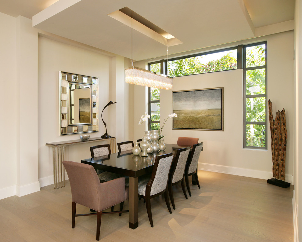 Photo of a contemporary dining room in Miami with white walls and medium hardwood flooring.