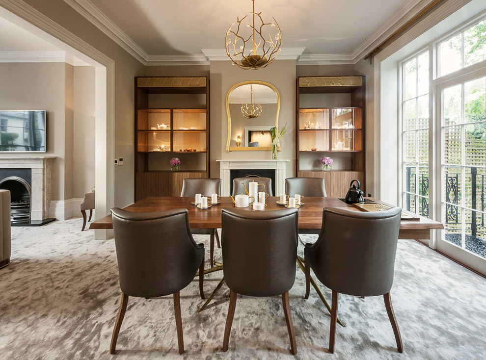 Inspiration for a classic dining room in London with grey walls, carpet and a standard fireplace.