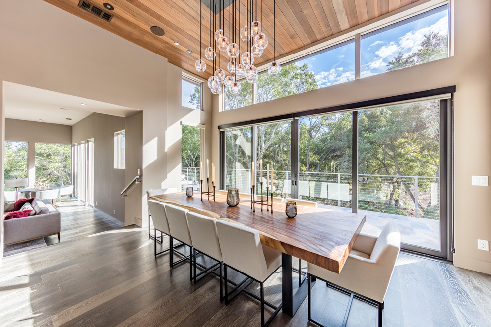 Expansive contemporary dining room in San Francisco with beige walls, dark hardwood flooring and grey floors.