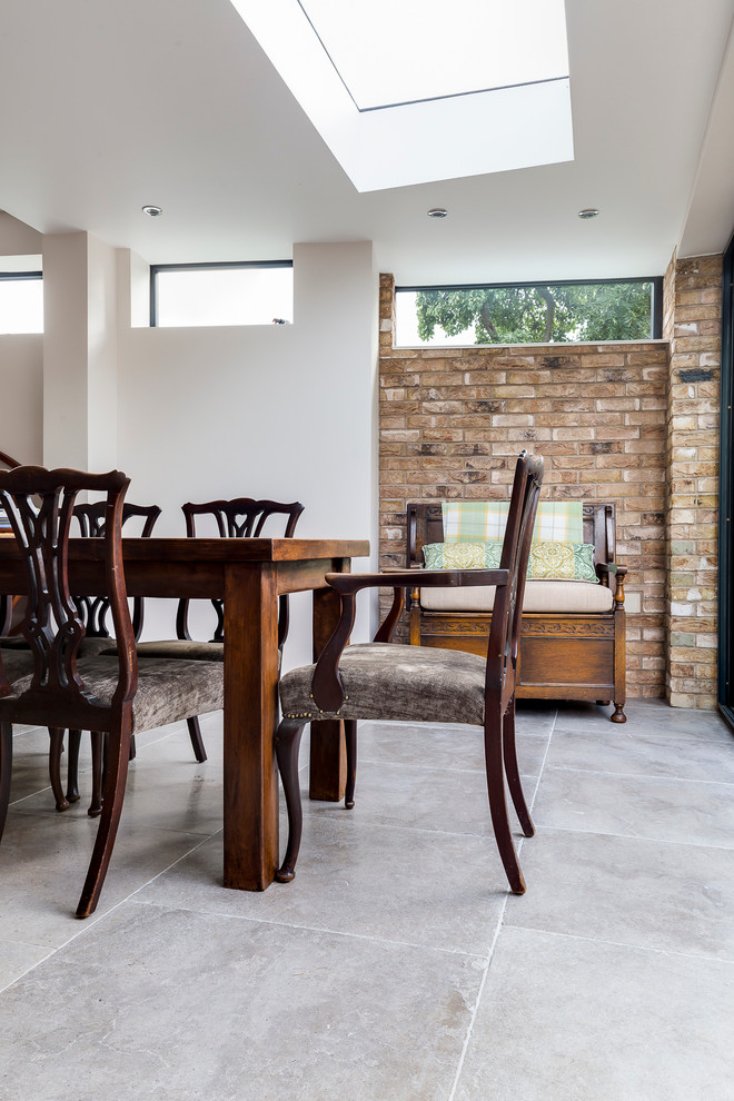 Example of an eclectic limestone floor dining room design in Wiltshire