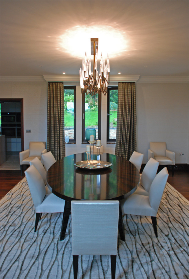 This is an example of a large classic dining room in Cornwall with white walls, dark hardwood flooring and brown floors.