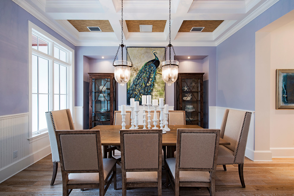 Inspiration for a coastal medium tone wood floor enclosed dining room remodel in Miami with purple walls