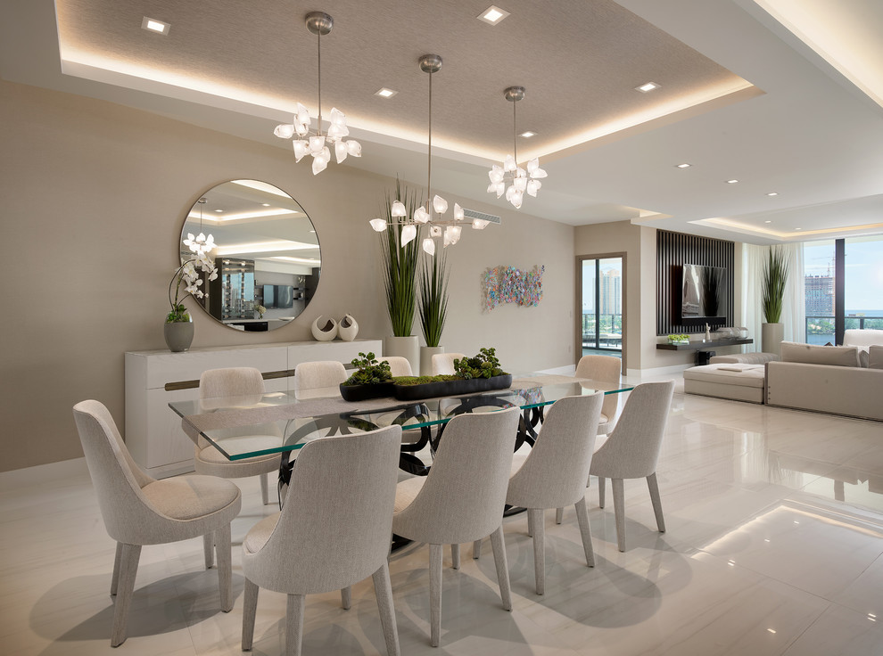 Inspiration for a contemporary dining room in Miami with beige walls and white floors.