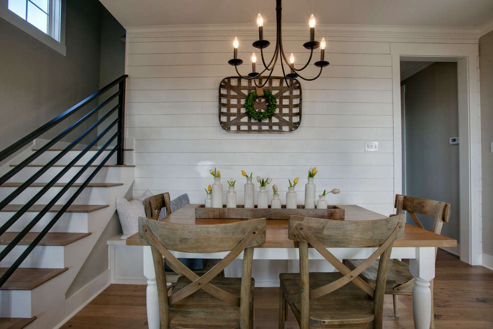 Exemple d'une salle à manger ouverte sur le salon nature de taille moyenne avec un mur blanc, un sol en bois brun, aucune cheminée et un sol marron.