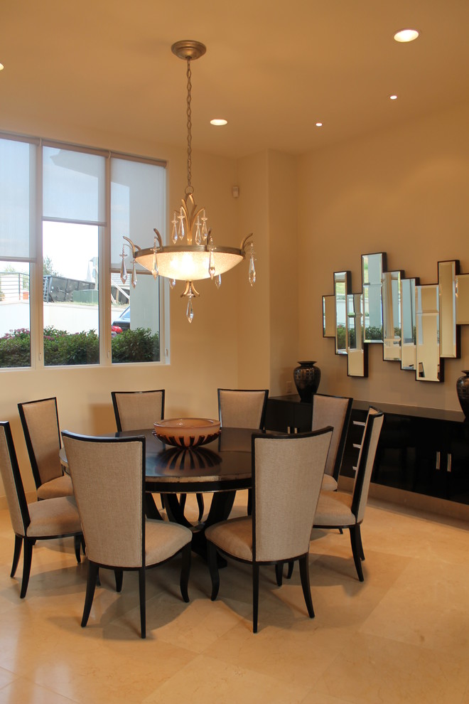 This is an example of a contemporary enclosed dining room in Dallas with beige walls and marble flooring.