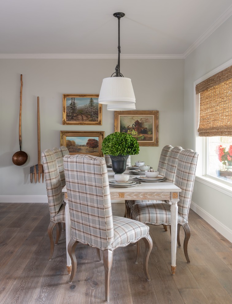 Elegant medium tone wood floor and brown floor dining room photo in Austin with gray walls