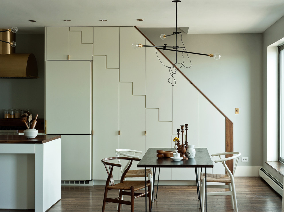 Minimalist dark wood floor kitchen/dining room combo photo in New York with gray walls
