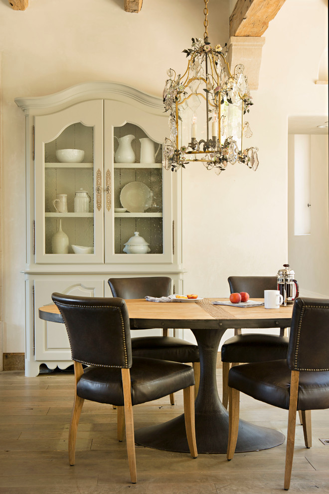 Dining room - mediterranean dining room idea in Orange County with white walls