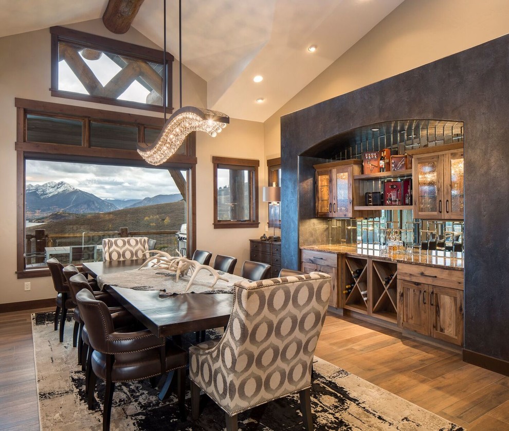 This is an example of a large rustic kitchen/dining room in Denver with beige walls, porcelain flooring, no fireplace and brown floors.