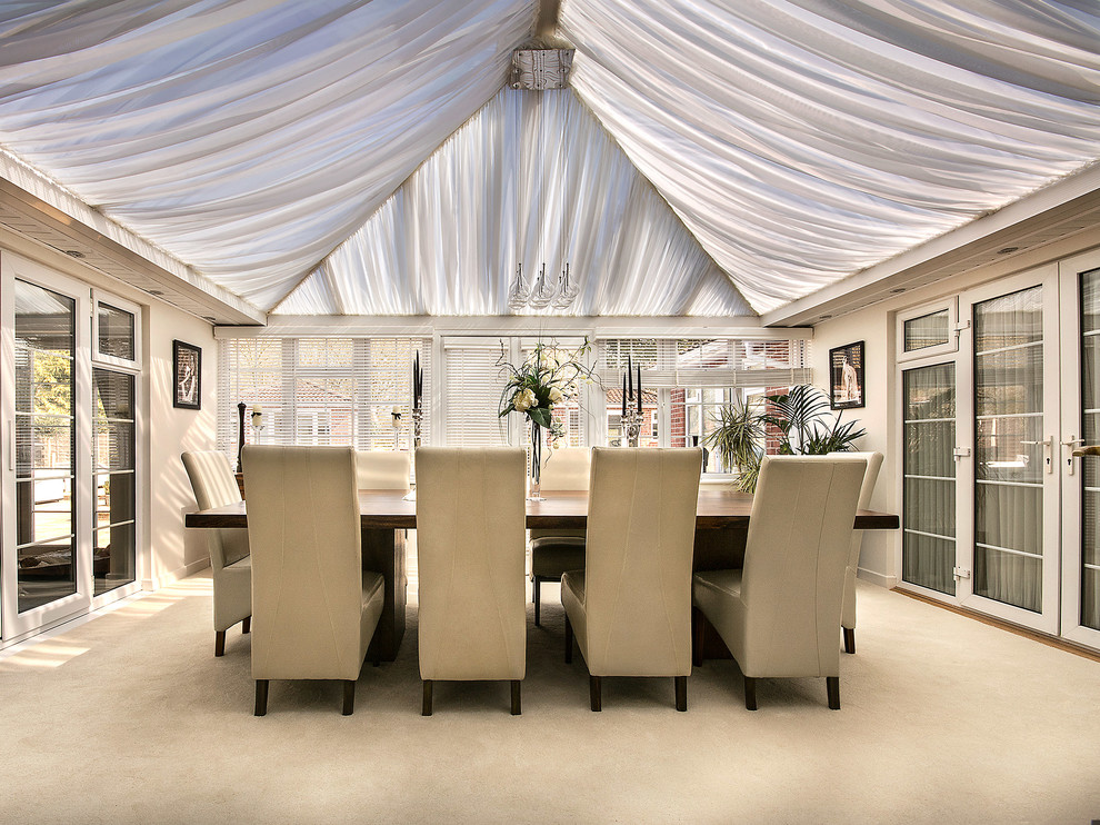 Photo of a large classic enclosed dining room in London with carpet.