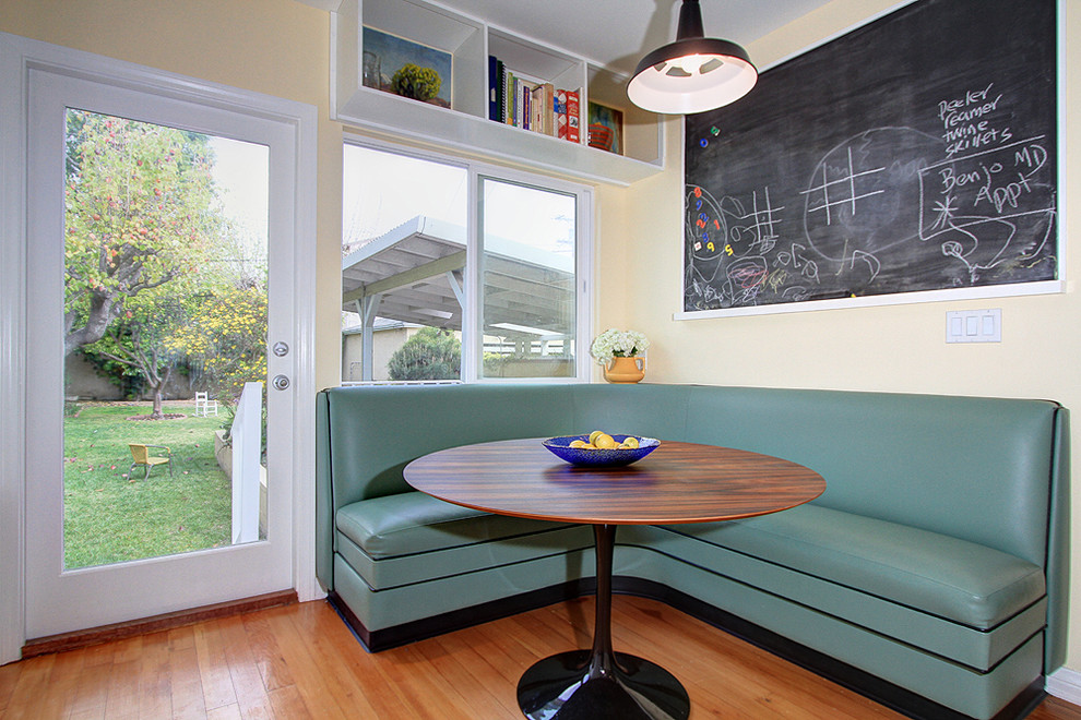 This is an example of a contemporary dining room in Los Angeles with beige walls and medium hardwood flooring.