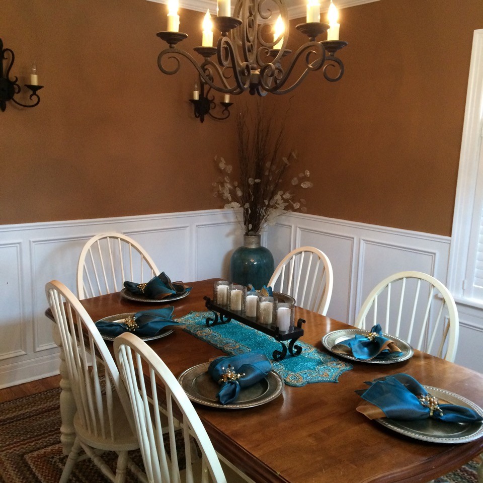 Inspiration for a mid-sized country light wood floor enclosed dining room remodel in Boston with brown walls