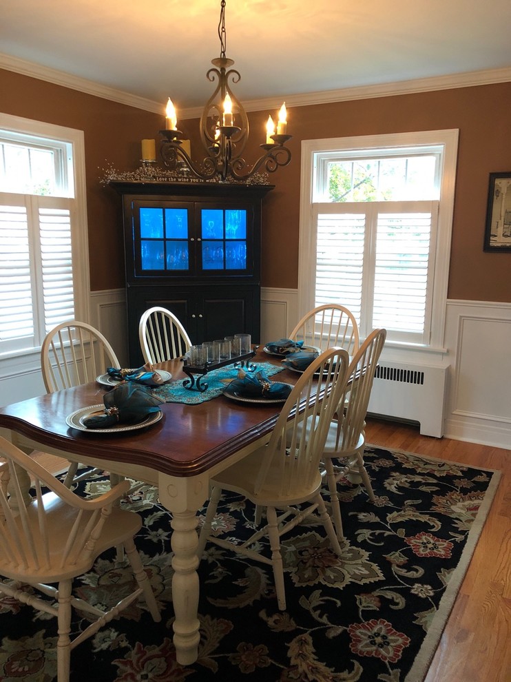 Example of a mid-sized country light wood floor kitchen/dining room combo design in Boston with brown walls