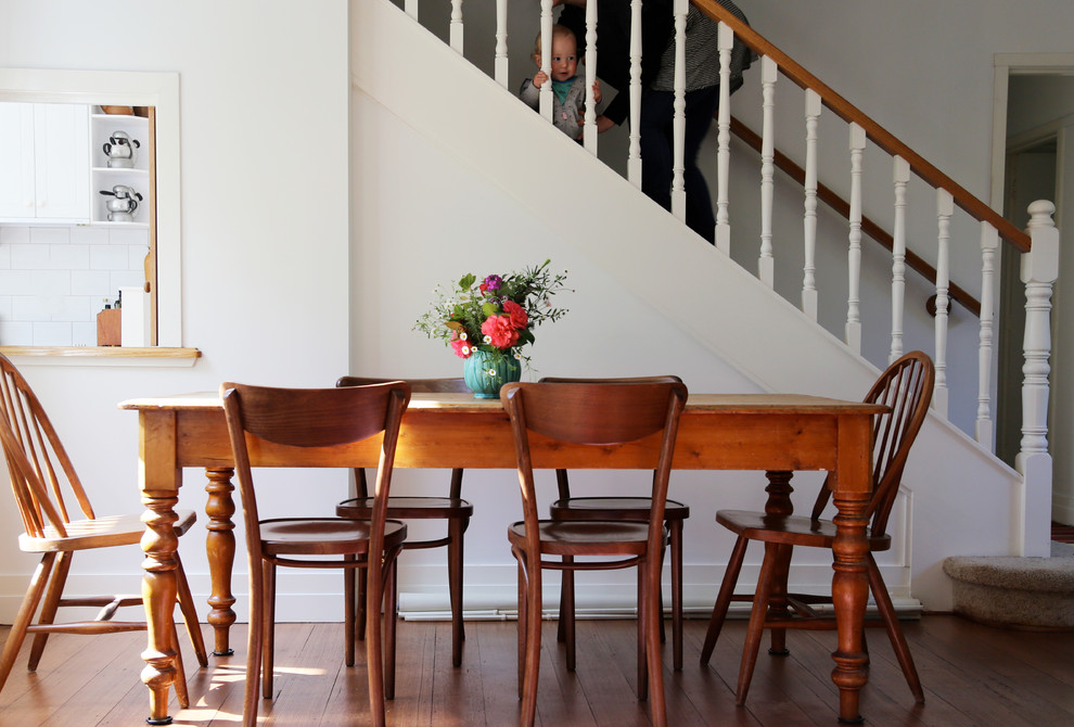 Farmhouse medium tone wood floor dining room photo in Melbourne with white walls