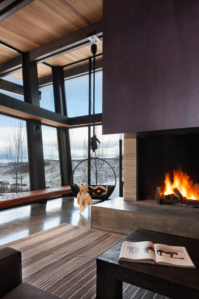 Photo of an expansive contemporary open plan dining room in Salt Lake City with concrete flooring, a corner fireplace, a metal fireplace surround and brown floors.