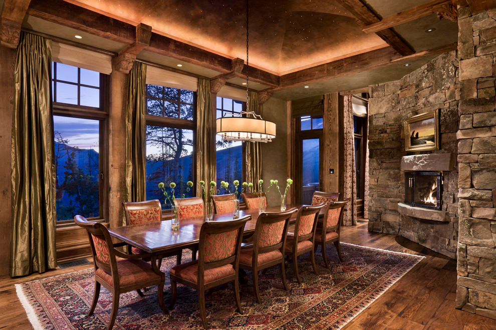 Inspiration for a rustic dining room in Other with a corner fireplace.
