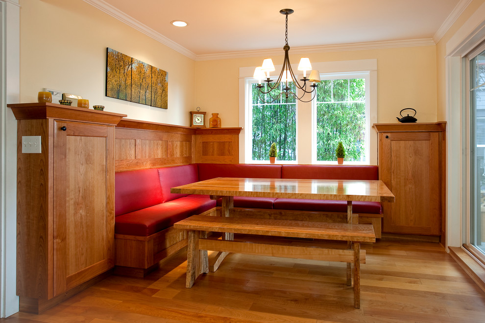 Example of a mid-sized arts and crafts medium tone wood floor enclosed dining room design in Seattle with yellow walls and no fireplace