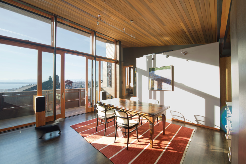 Design ideas for a modern open plan dining room in Seattle with dark hardwood flooring.