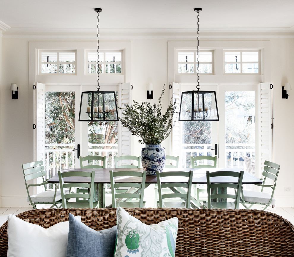 Inspiration for a coastal dining room in Sydney with beige walls, painted wood flooring and white floors.