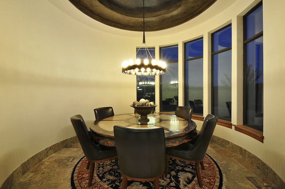 This is an example of a mediterranean dining room in Austin with beige walls.