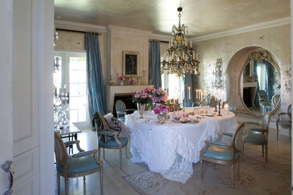 Inspiration for a large shabby-chic style enclosed dining room in Los Angeles with light hardwood flooring, beige walls and a standard fireplace.