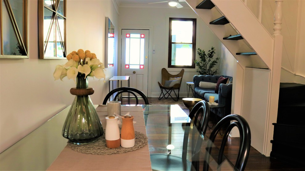 Exemple d'une petite salle à manger ouverte sur le salon victorienne avec un mur gris, parquet clair, une cheminée standard et un manteau de cheminée en bois.