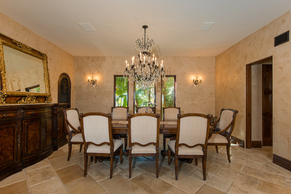 Example of a mid-sized tuscan ceramic tile and brown floor enclosed dining room design in Los Angeles with beige walls and no fireplace