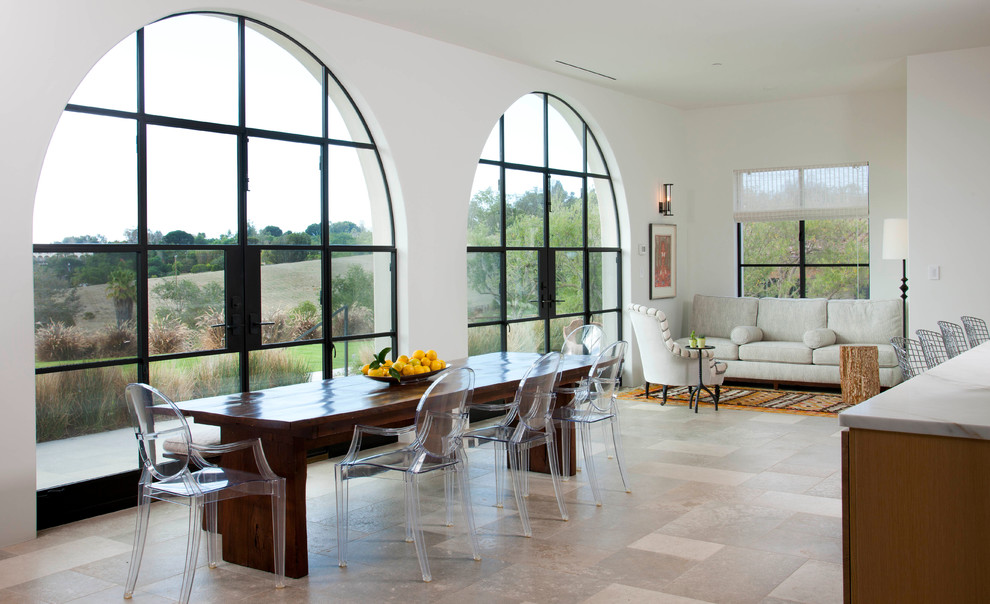Mediterranean open plan dining room in San Diego with white walls.