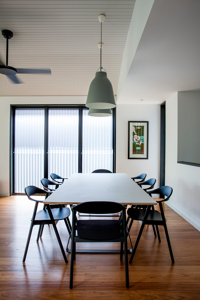 Inspiration for a contemporary dining room in Sydney with white walls, dark hardwood flooring and brown floors.