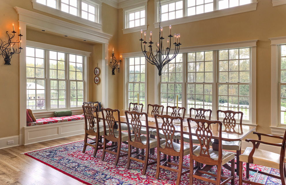 Aménagement d'une très grande salle à manger ouverte sur la cuisine classique avec un sol en bois brun.