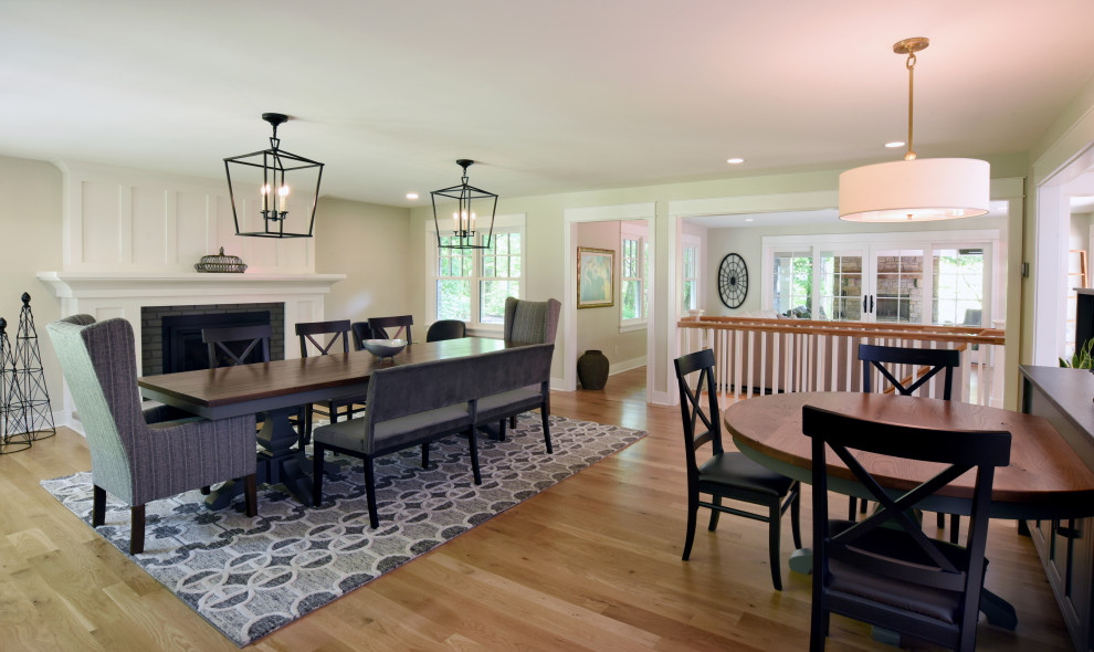 Mid-sized transitional light wood floor and beige floor kitchen/dining room combo photo in Columbus with beige walls, a standard fireplace and a wood fireplace surround