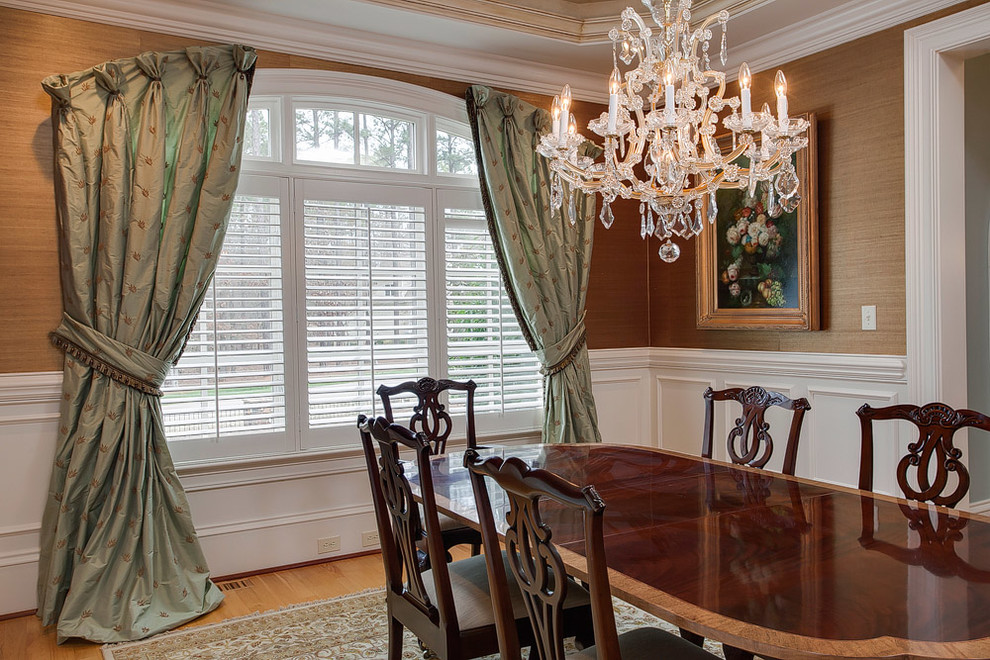 Mid-sized elegant medium tone wood floor dining room photo in Raleigh with metallic walls