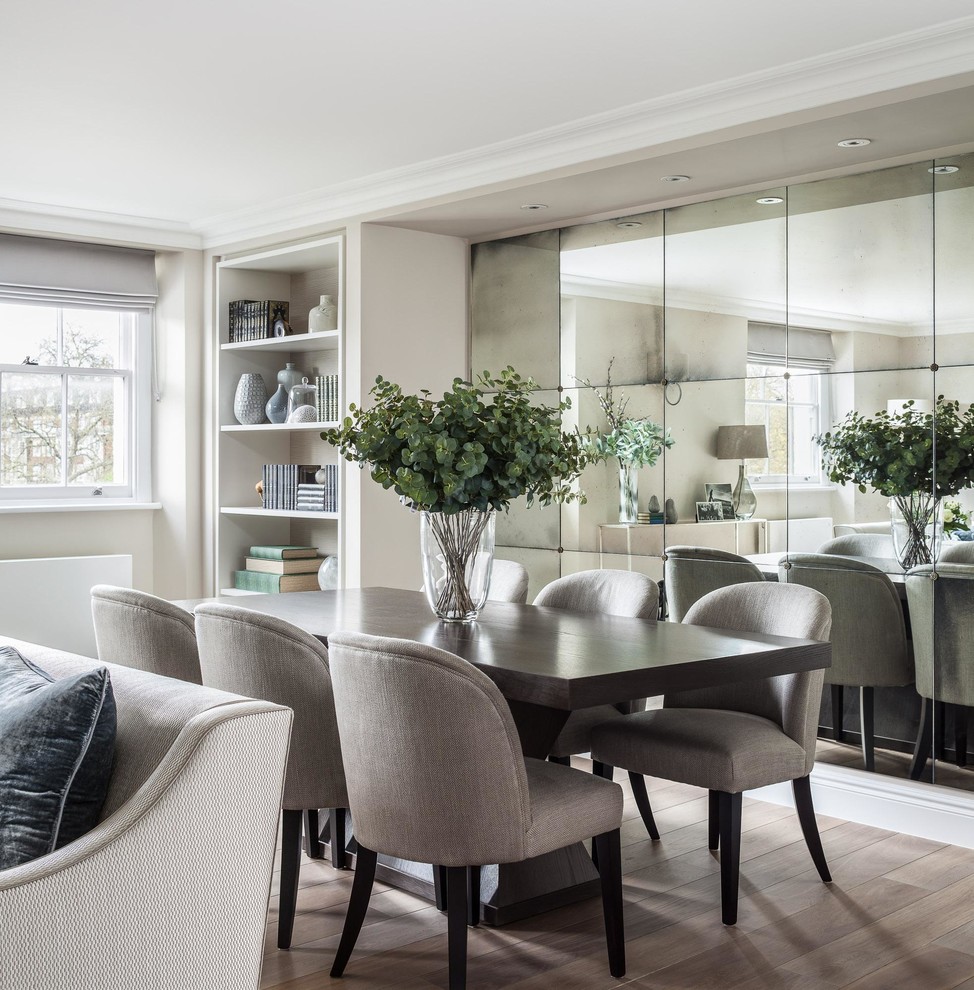 Medium sized classic dining room in London with beige walls, light hardwood flooring, beige floors and feature lighting.