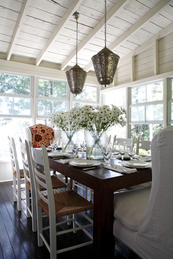 Photo of a beach style dining room in Other with white walls, dark hardwood flooring and brown floors.