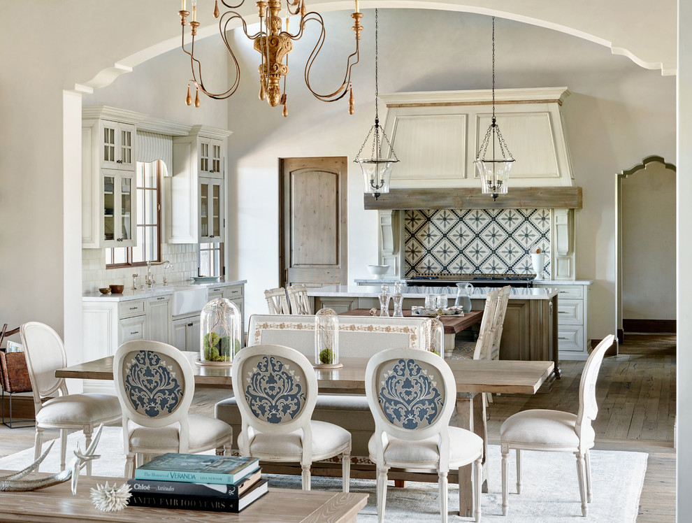 Design ideas for a mediterranean open plan dining room in Phoenix with medium hardwood flooring and beige walls.